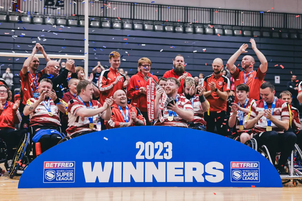 Wigan Warriors wheelchair rugby team celebrating after winning the 2023 Wheelchair Super League 